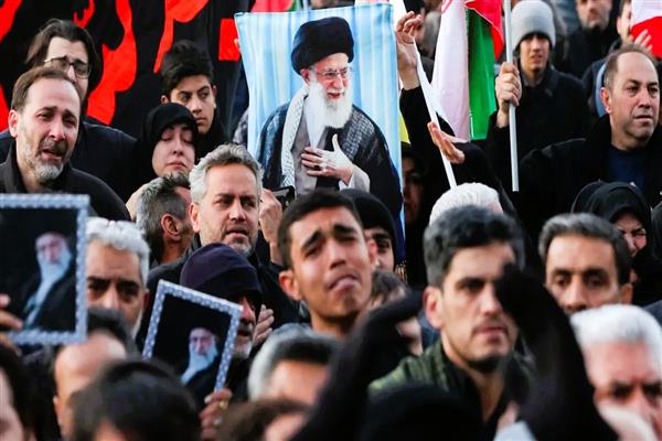 Mourners hold portraits of Iran’s Supreme Leader Ayatollah Ali Khamenei during a gathering in Kashmir following reports of his killing.
